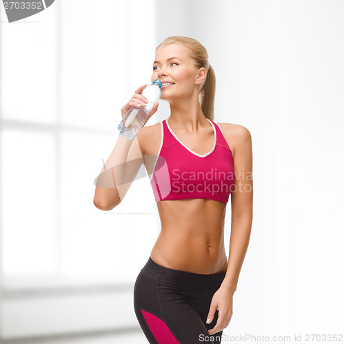 Image of smiling woman with bottle of water