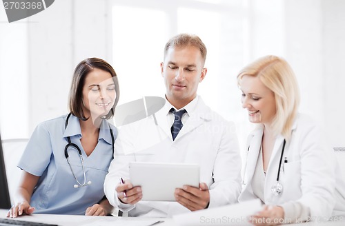 Image of doctors looking at tablet pc