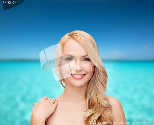 Image of face and shoulders of happy woman with long hair