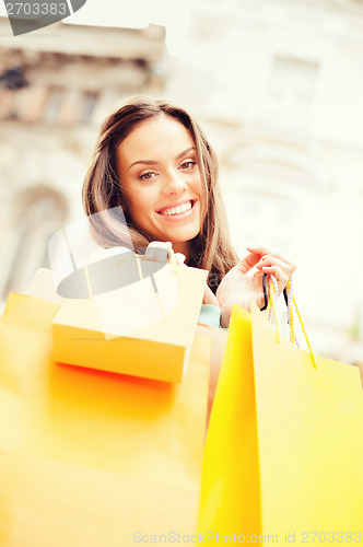 Image of woman with shopping bags in city