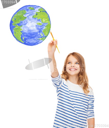 Image of cute little girl drawing with brush planet earth