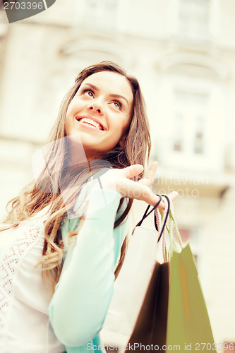 Image of woman with shopping bags in city