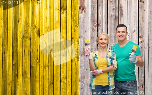 Image of smiling couple with paintbrush