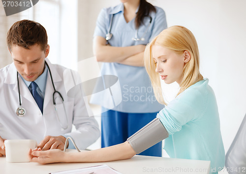 Image of male doctor, female nurse and patient in hospital