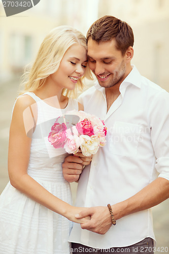 Image of couple with flowers in the city