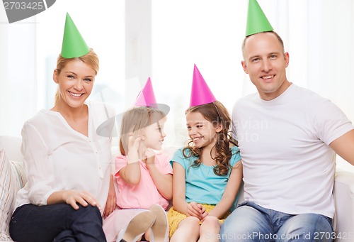 Image of happy family with two kids in hats celebrating