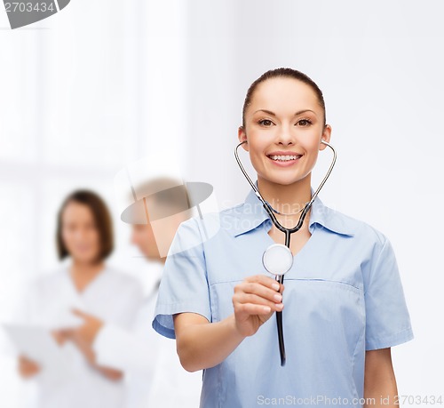Image of smiling female doctor or nurse with stethoscope