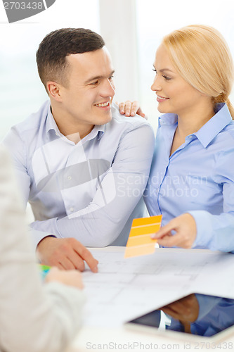 Image of couple looking at blueprint and color samples