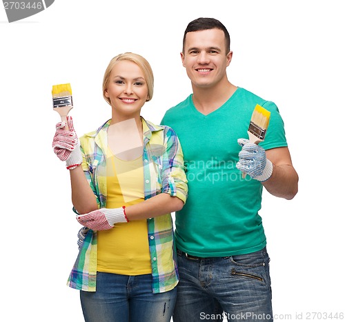 Image of smiling couple with paintbrush