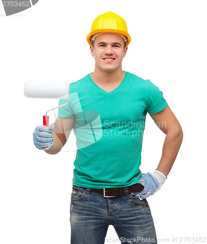 Image of smiling manual worker in helmet with paint roller