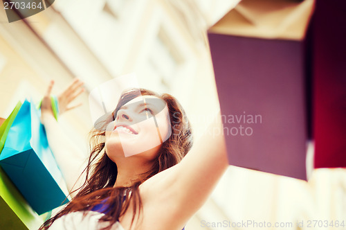 Image of woman with shopping bags in city