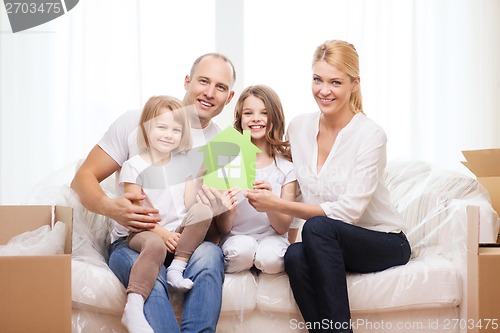 Image of smiling parents and two little girls at new home