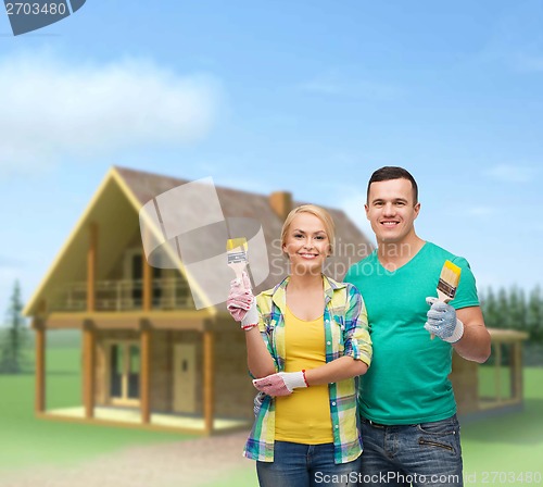 Image of smiling couple with paintbrush