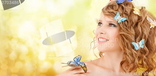 Image of happy teenage girl with butterflies in hair