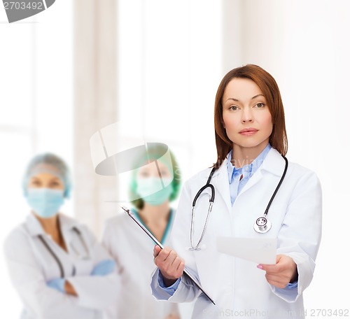 Image of calm female doctor with clipboard