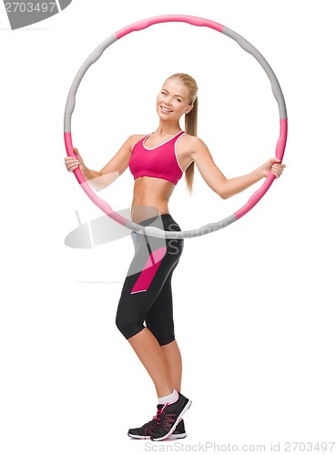 Image of young sporty woman with hula hoop