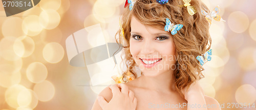 Image of happy teenage girl with butterflies in hair