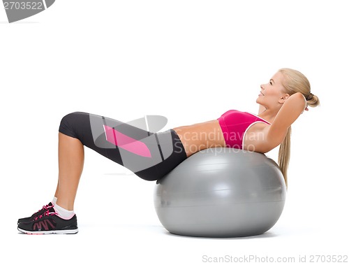 Image of smiling woman with fitness ball