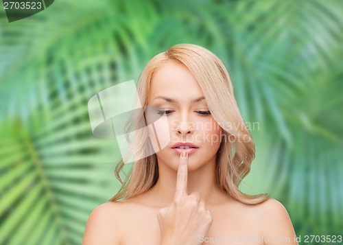 Image of woman touching her lips