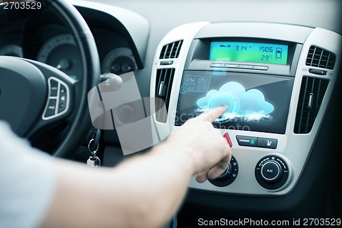 Image of man using car control panel