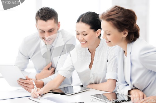 Image of business team working with tablet pcs