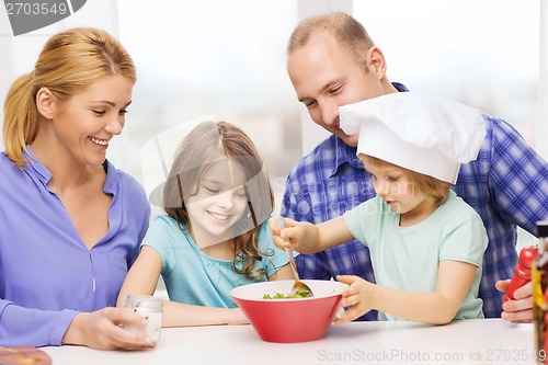 Image of happy family with two kids eating at home