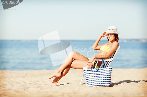 Image of girl sunbathing on the beach chair