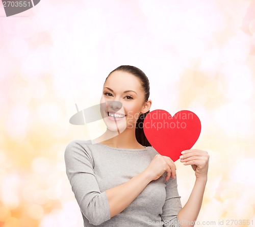 Image of smiling asian woman with red heart