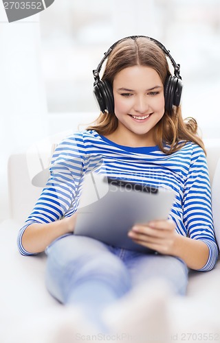 Image of girl with tablet pc and headphones at home