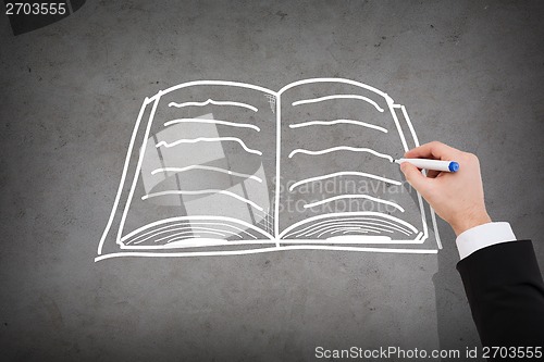 Image of close up of businessman drawing book