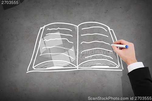 Image of close up of businessman drawing book