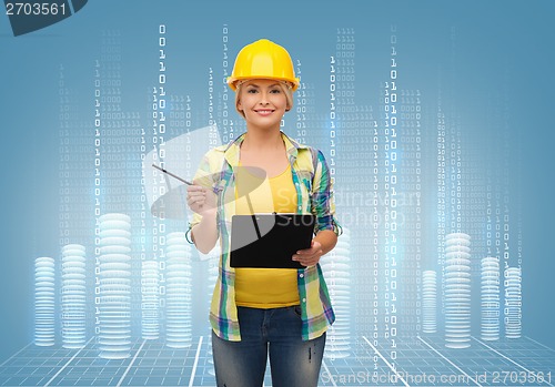 Image of smiling woman in helmet with clipboard