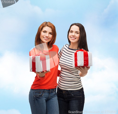 Image of two smiling teenage girls with presents