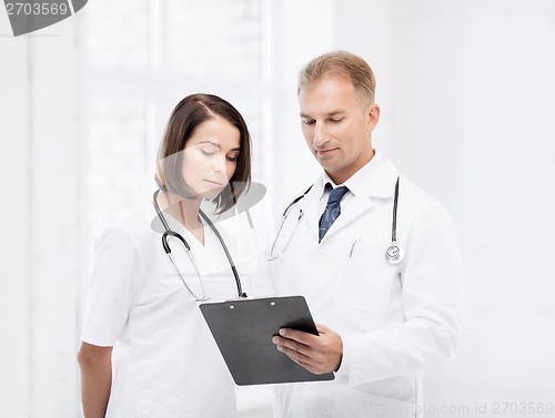 Image of two doctors writing prescription