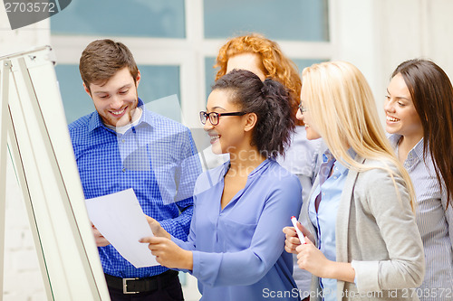 Image of smiling business team having discussion in office