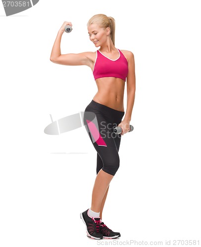 Image of young sporty woman with light dumbbells