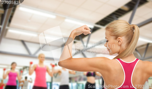 Image of sporty woman showing her biceps