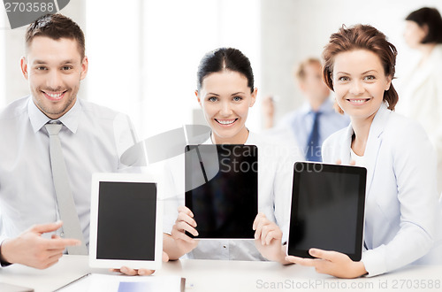 Image of business team showing tablet pcs in office