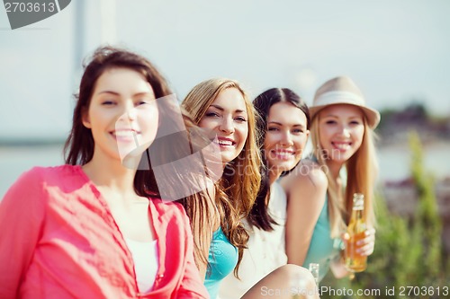 Image of girls with drinks on the beach