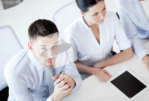 Image of serious businessman on meeting in office