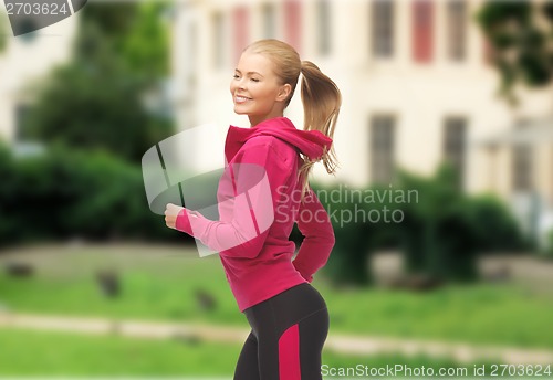 Image of sporty woman running or jumping