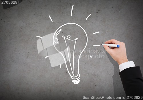 Image of close up of businessman drawing light bulb