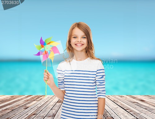 Image of smiling child with colorful windmill toy