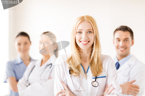 Image of female doctor or nurse in front of medical group