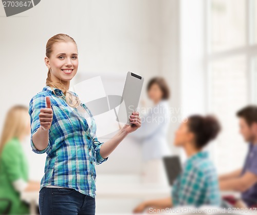 Image of smiling girl with tablet pc computer at classroom