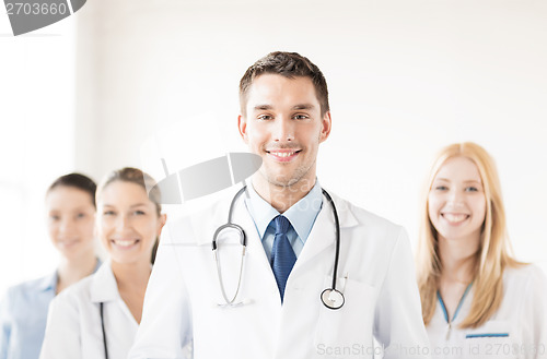 Image of male doctor in front of medical group