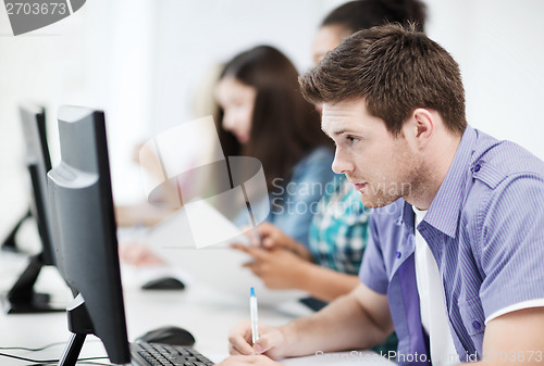 Image of student with computer studying at school