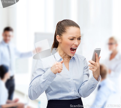 Image of screaming businesswoman with smartphone