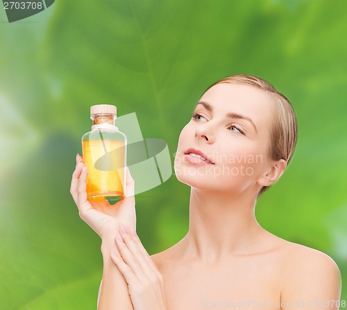 Image of lovely woman with oil bottle