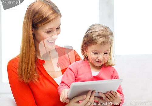 Image of happy mother and daughter with tablet pc computer
